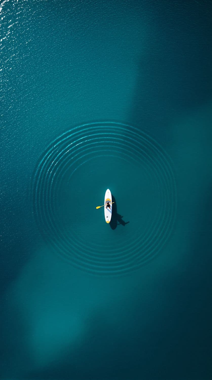 Solitary Paddleboarder on Turquoise Waters